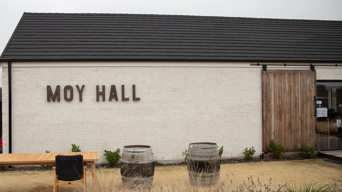 Moy Hall cellar door, a white brick building with a sliding barn door