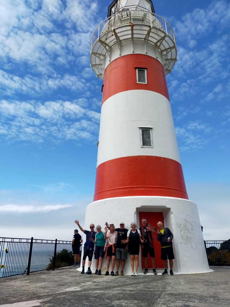 A tour group at the base of Cape Palliser lighthouse